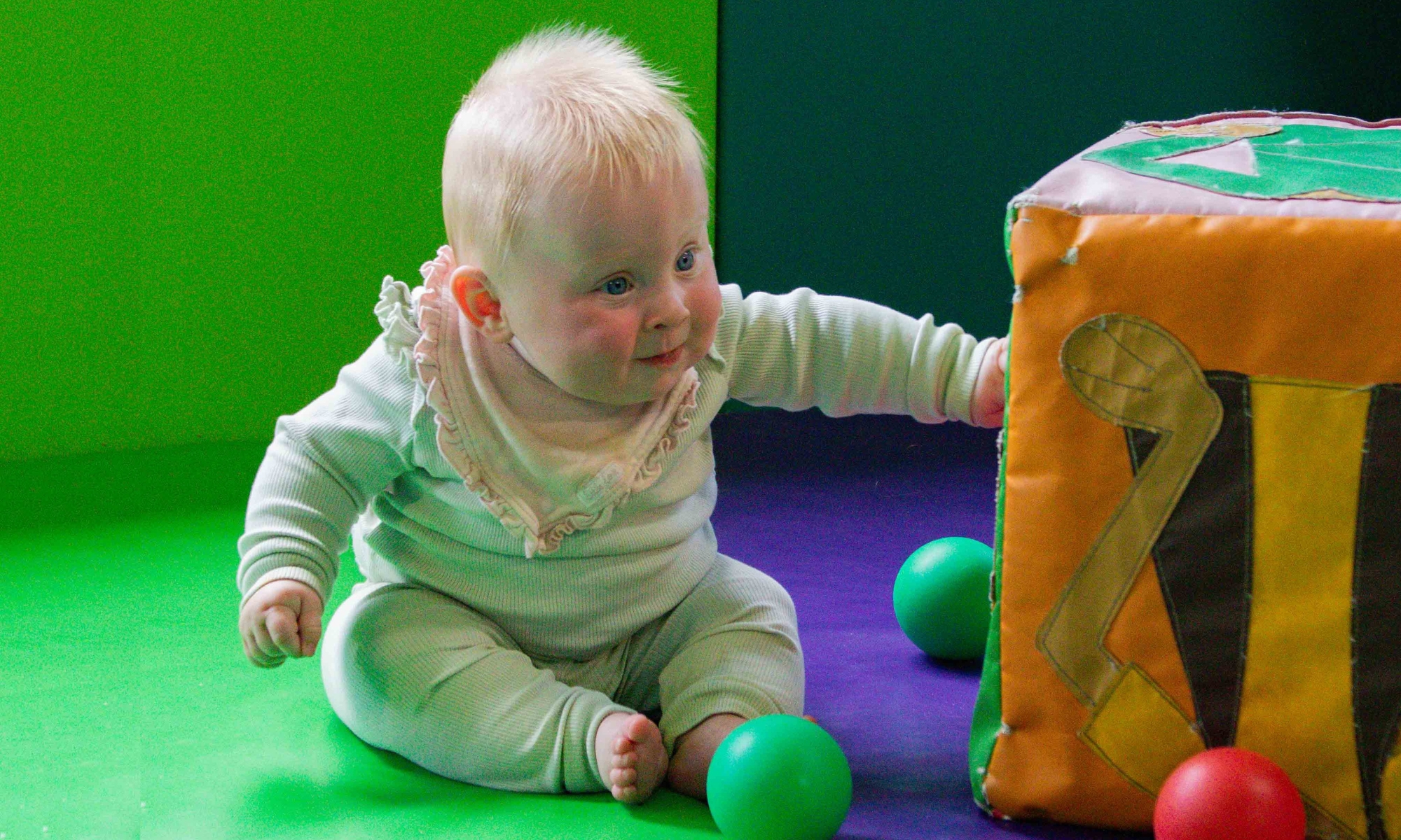 Infant playing in the Play Barn Café soft play at Wroxham Barns.