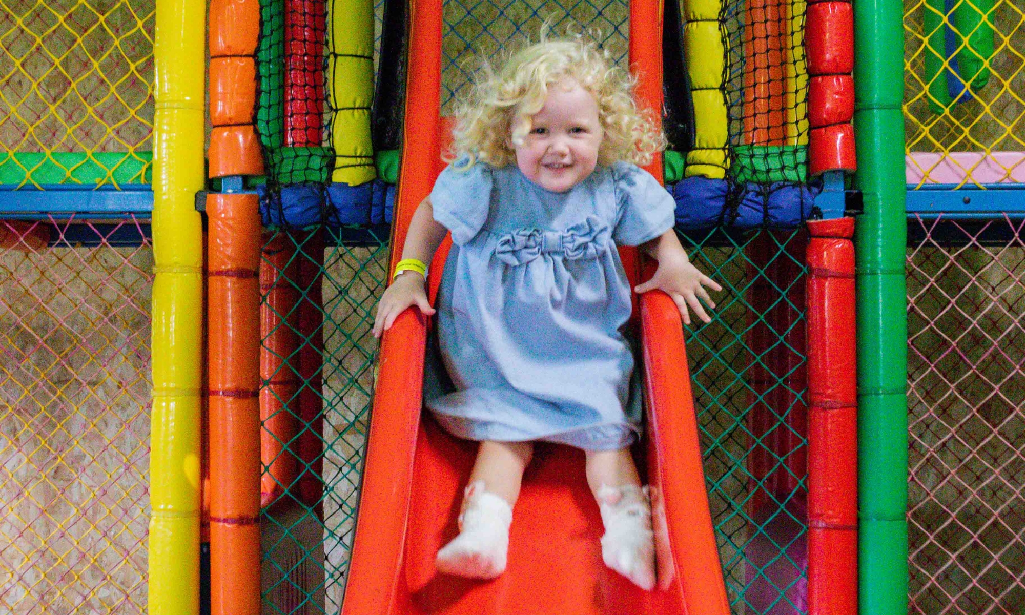 Child going down the slide in the Play Barn Café at Wroxham Barns.